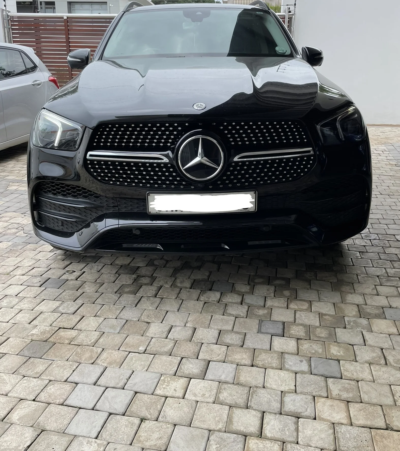 Glossy black Mercedes-Benz SUV after detailing