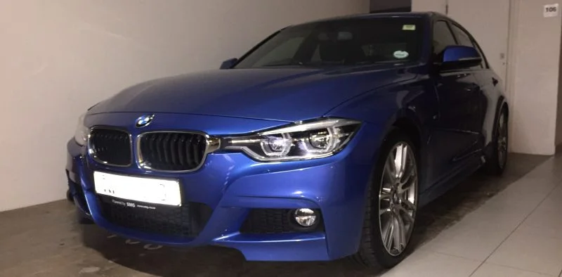 Blue BMW saloon with a clean reflective finish
