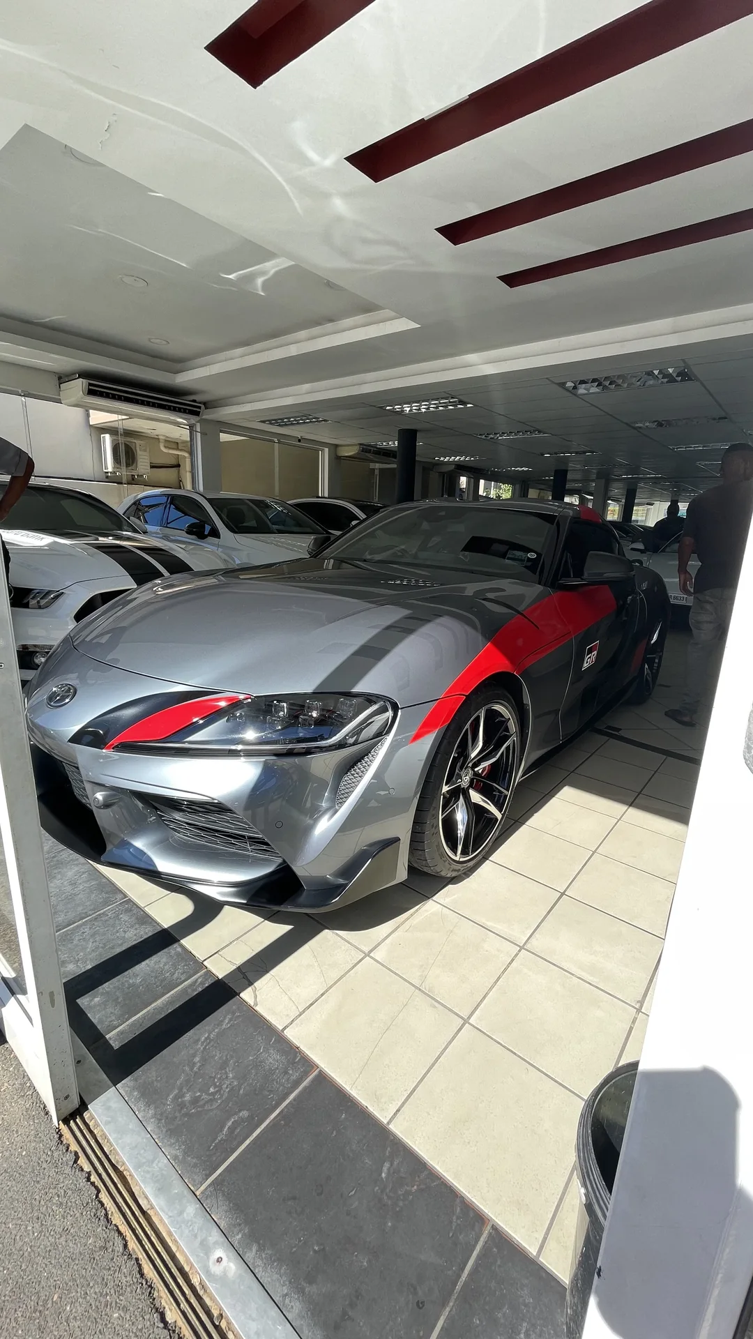 Silver sports car with a clean reflective finish indoors